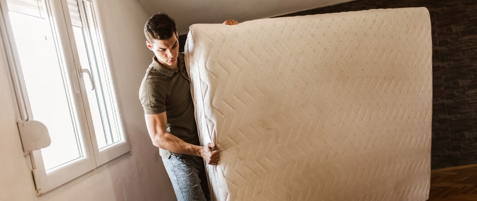 man moving mattress